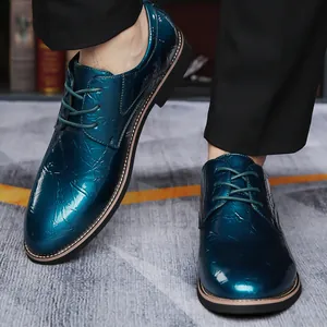 Macro view of glossy teal men's oxfords featuring unique crinkled texture and lace-up design