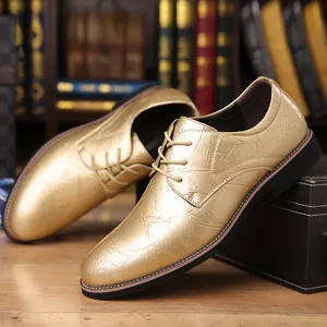Detailed view of golden metallic textured men's formal dress shoes with lace-up design