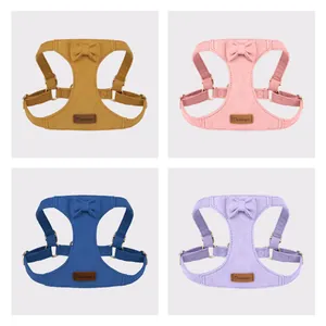 Four-color soft suede dog harness vest with cute bow tie detail and durable metal hardware.