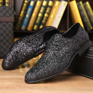 Detailed close-up of men's black glitter lace-up oxford shoes for formal events
