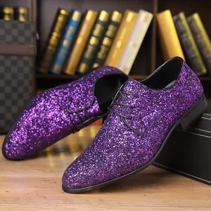 Detailed macro shot of stylish men's purple glitter lace-up dance shoes on a wooden table