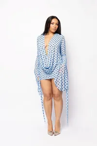 Close-up of a blue polka dot deep V-neck mesh bodycon mini dress on a model.