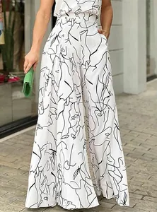 Detail shot of white wide-leg jumpsuit featuring a minimalist black face line art print.