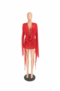 Red polka dot bodycon dress with deep V-neck and long sleeves on mannequin