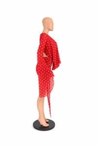 Side view of red polka dot bodycon dress with deep V-neck and bell sleeves
