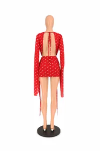 Back detail of a red polka dot mini dress with sexy open back and flared long sleeves.