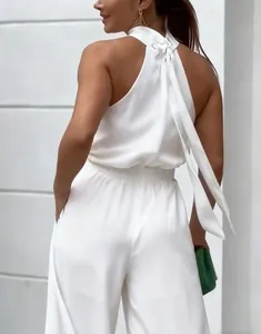 Back view of elegant white halter neck jumpsuit with tie back detail and wide legs