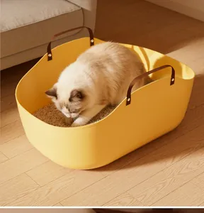Portable yellow cat litter box with handles shown in a cozy home setting with a cat inside