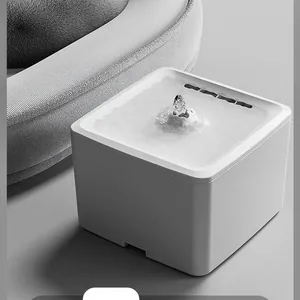 Close-up detail of automatic white pet water fountain with bubbling water flow.