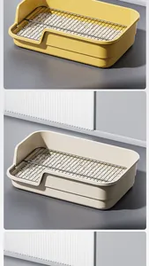Large splash-proof dog litter box with high fence and black metal grate, yellow and beige