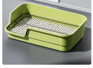 Detailed view of large green dog litter box with high splash-proof fence and metal grid.
