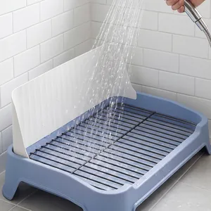 Detail view showing the easy-to-clean iron mesh dog toilet with a shower spray.
