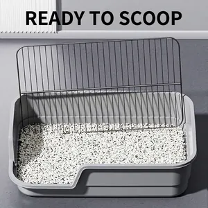 Large grey dog toilet with high fence and metal grid for anti-splash protection in grey