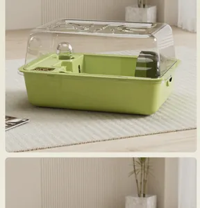 Detailed view of a spacious green hamster cage featuring a transparent top lid and accessories.