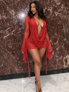 Elegant red polka dot mini dress featuring a deep V-neck and long flared sleeves