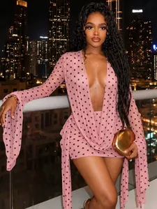 Pink polka dot deep V mini dress featuring long flared sleeves for evening party wear