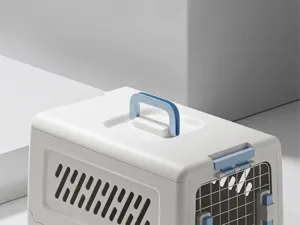 Detailed view of the portable pet carrier showing the sturdy blue handle and ventilation.