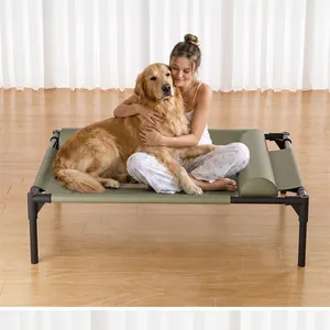 Golden retriever dog and woman sitting on a sturdy elevated green faux leather dog cot.