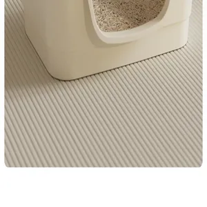 Macro detail of a cream-colored anti-tracking cat litter mat with a ribbed texture