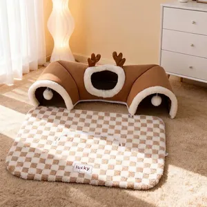 Detachable reindeer themed cat tunnel bed with checkered plush mat in warm home setting.