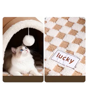 Cozy brown plush tunnel cat bed featuring a hanging pom-pom toy and checkerboard fabric