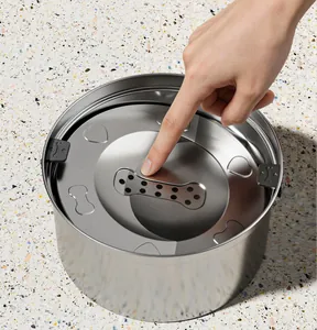 Close-up of stainless steel pet water bowl featuring a floating disk and filter.