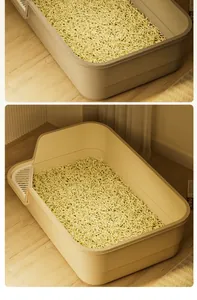 High-angle macro detail of a semi-enclosed cat litter box filled with tofu litter.