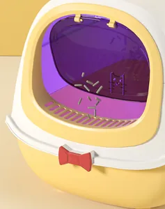 Close-up of large enclosed cat litter box with purple door and cute red bow decoration.