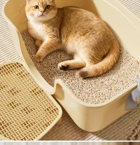 Extra large cream colored cat litter box with litter tracking mat and a cat inside