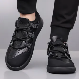 Close-up of stylish black platform dad sneakers with HKG 852 ribbon detail on feet.