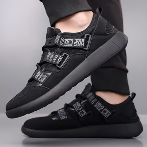 Close-up detail of black retro platform sneakers featuring mesh upper and decorative straps