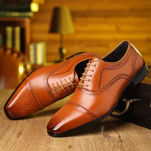 Detail of brown leather brogue shoes with carved wingtip patterns for formal business