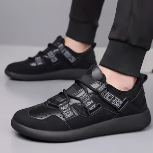 Close-up of black thick-soled dad sneakers with mesh and strap details