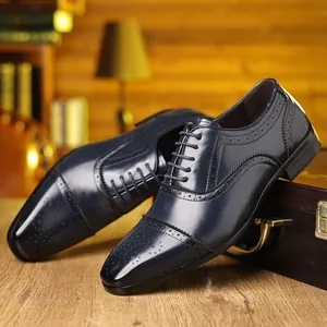 Detail view of navy blue brogue Oxford shoes with elegant leather perforations