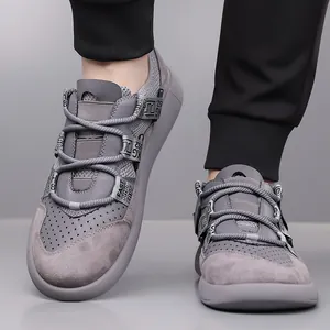 Close-up of grey chunky platform sneakers with retro design and decorative text straps