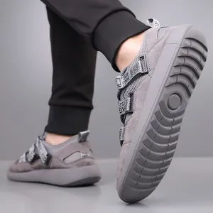 Detailed view of grey chunky sole retro sneakers with unique decorative tape straps.