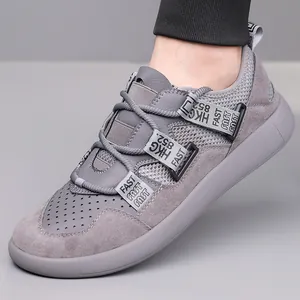 Close-up of grey retro chunky sneaker featuring decorative FAST straps and mesh fabric