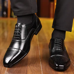 Close-up of elegant men's black leather Brogue dress shoes with classic carved details