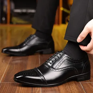 Detailed view of men's black Brogue leather dress shoes with decorative perforations