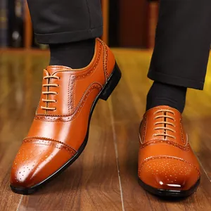 Detailed view of tan leather Brogue shoes with intricate perforated wingtip design.
