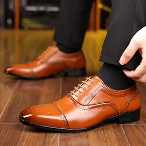 Detailed view of brown leather brogue shoes with elegant wingtip perforations.