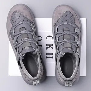 Close-up top view of grey chunky platform sneakers with retro mesh and leather textures.