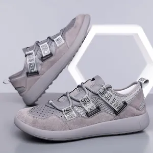 Side view of women's grey retro chunky sneakers with decorative straps and mesh detail