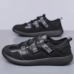 Side view of black women's chunky sneakers with decorative straps and thick sole