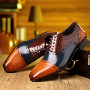 Close-up of tricolor brogue oxfords with intricate carved detailing and laces.