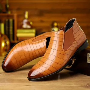 Detailed side view of tan alligator embossed men's business casual leather Chelsea boots