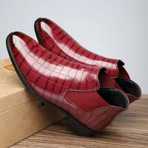 Detailed close-up of dark red men's business Chelsea boots with crocodile skin texture.
