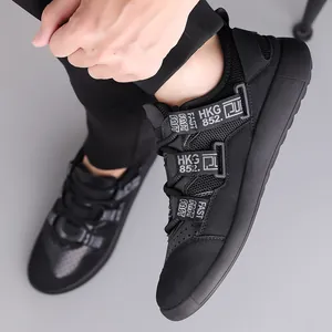 Detail of black chunky sneakers featuring industrial style straps and mesh texture