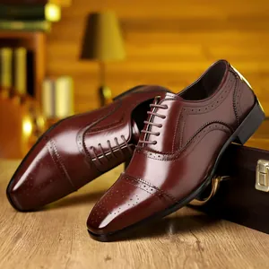Detail shot of brown brogue Oxford leather shoes with elegant perforated wingtip design.