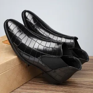Detail view of black crocodile embossed finish on men's business casual Chelsea boots